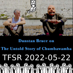 Dunstan sitting by a wall with someone wearing the baby face from the Tubthumper album cover and cartoon hands from \"Never Mind The Ballots\" album cover