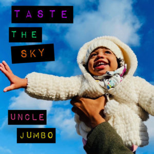Cover image for Uncle Jumbo's Taste the Sky album, featuring a photo of a joyfully smiling child in a fluffy white hooded jacket being held up by an adult hand, with a backdrop of a blue sky with a few clouds.